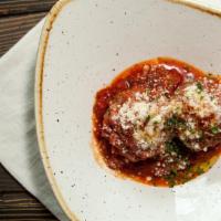 Meatballs With Italian Tomato Sauce · Two homemade beef meatballs with tomato sauce.