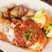 Chicken Parmigiana · A lightly breaded chicken breast baked with marinara sauce and cheese.