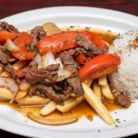 Lomo Saltado · Sauteed beef churrasco grilled with onions, tomatoes, french fries and a side of rice.