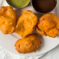 Onion Pakora · Onions dipped in chickpeas batter and deep fried.