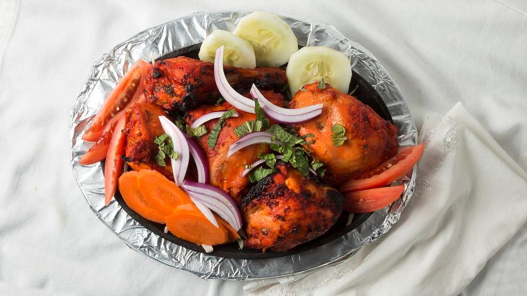 Tandoori Chicken · Chicken on the bone marinated with spices and cooked in our tandoori oven.