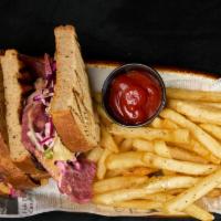 Reuben Sandwich · Shaved corn beef, sauerkraut and swiss, heated together for flavor topped with chef sauce.