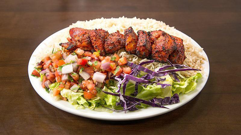 Tandoori Shish Kabob · Tender Cubes Of Boneless Chicken Breast Marinated Seasoned With the spicy Tandoori Masala Special House Spices & Grilled To Perfection. Served With A Salad & Afghan Rice.