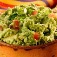 Guacamole · Hand smashed guacamole with fresh avocado, cilantro, onions, and lime topped with pico.