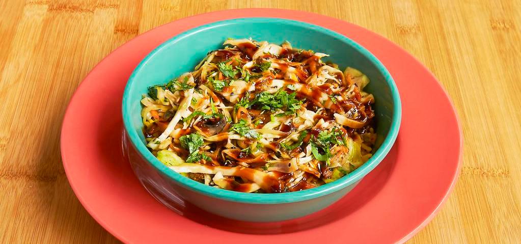 Asian Rice Bowl · Kahuna rice, mushrooms, onion, carrots, edamame, cabbage, Korean BBQ sauce, sesame slaw, scallions. And yellow rice.