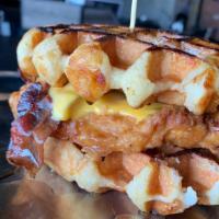 Chicken  &  Waffle Sandwich · Hand battered fried chicken, American cheese, & bacon between two Belgian waffles. Maple Syr...