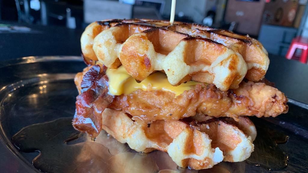 Chicken  &  Waffle Sandwich · Hand battered fried chicken, American cheese, & bacon between two Belgian waffles. Maple Syrup on the side