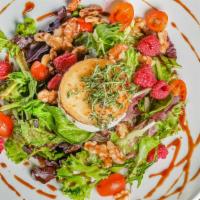 Ensalada De Queso De Cabra · Mixed green Salad, nueces, raspberry, Tomate cherry, queso de cabra y vinagreta de raspberry