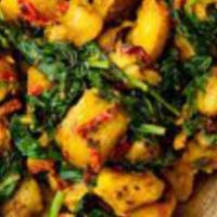Alu Sag · The traditional green based vegetarian dish is made with potatoes cooked in a onion-tomato-s...