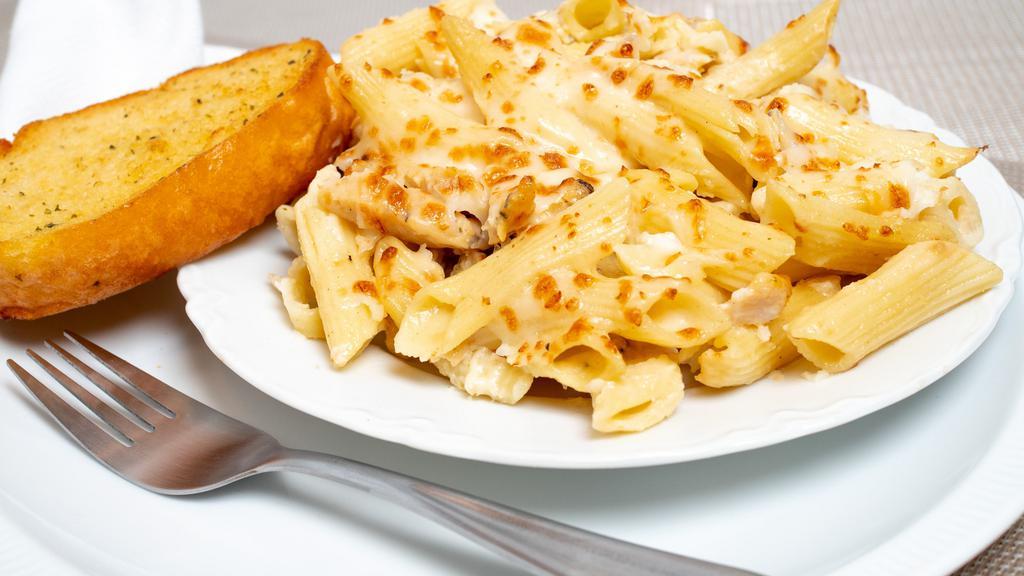 Chicken Alfredo Bake · Penne pasta served with slice grilled chicken and tossed with creamy Alfredo sauce. Topped with mozzarella cheese and baked to perfection. Served with a slice of garlic bread.