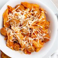 Mini Meatball Bake · Penne pasta generously covered with alfredo and marinara sauces, layered with tender mini me...