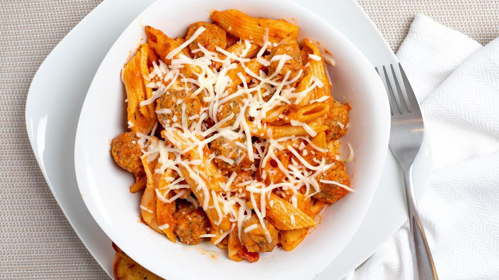 Mini Meatball Bake · Penne pasta generously covered with alfredo and marinara sauces, layered with tender mini meatballs, toasted herbs and a delicious combination of cheeses; baked to perfection. Served with a slice of garlic bread.