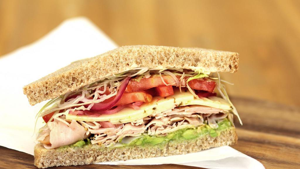 Baja Chipotle Turkey · Turkey, chipotle honey yogurt dressing, shaved cabbage, pickled red onions, tomato, avocado, pepper Jack cheese, salt and pepper with your choice of bread.