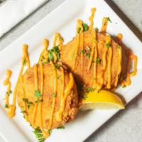 Crab Cakes · 2 Fried Crab Cakes, Drizzled with chipotle aioli on top.