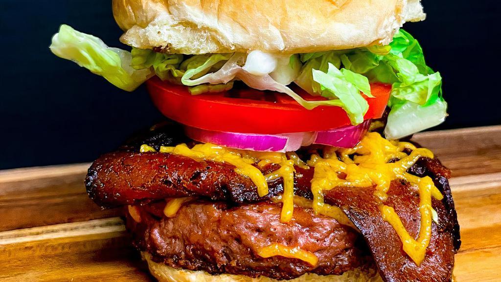 Banging Bacon Cheese Burger · Hickory smoke tempeh bacon, vegan cheese, lettuce, tomato, plant based burger, onion, vegan mayo on a toasted bun.