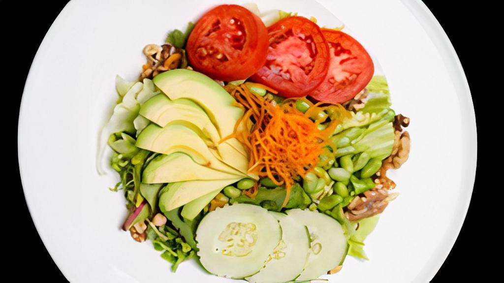 Happy Salad · A happy blend of tomatoes, cucumbers, organic edamame, avocado, fried red onions, carrots, and walnuts. The salad features organic greens. Choice of Sesame Vinaigrette or Peanut sauce dressing