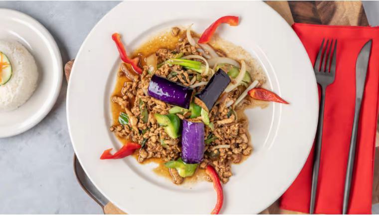 Hot Stuff Kra Pow · Spicy basil, eggplant, green onions, bell peppers and holy basil stir-fried in our flavorful brown chili sauce. Served with steamed jasmine rice