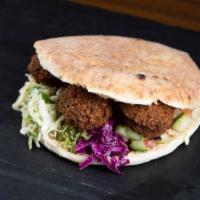 Falafel Sandwich · 5 Falafel balls in a freshly baked pita with hummus and salad toppings.