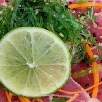 Tuna Tataki · Thin slices of seared tuna with ponzu sauce. **Raw/undercooked**