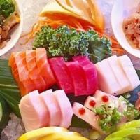 Sashimi Deluxe · Chef choice sushi roll and 15 pcs of sashimi **Raw/undercooked**. (Substitutions)