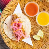 Cochinita Pibil Taco · Spicy. Pulled pork cooked in a red achiote salsa, topped with pickled red onion and habanero...