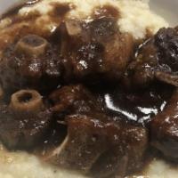 Oxtail & Grits · Served over bowl of grits.
