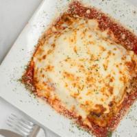 Lasagna · Homemade lasagna with layers of cheese and seasoned ground beef.