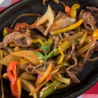 Steak Fajitas · Grilled steak cooked with onions and bell peppers in our own special sauce. Served with a si...