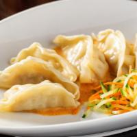 Pot Stickers With Red Curry · Delicate vegetable and pork dumplings served in a red curry sauce.