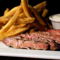 Steak Frites · 10 oz marinated flat iron steak, sliced with herb butter and served with parmesan truffle fr...