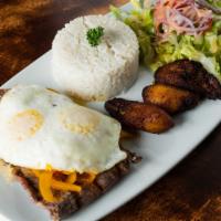 Steak With Homemade Sauce · Grilled steak top with a fried egg, served with rice, fried sweet plantain and salad.
