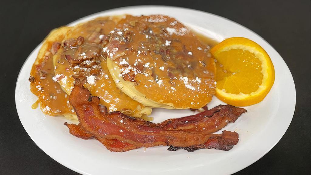 Bacon Praline Pancakes · Our Classic Buttermilk Pancakes filled with Applewood-Smoked Bacon and Toasted Pecans, topped with a warm brown sugar & butter caramel sauce. Served with applewood-smoked bacon