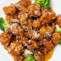 Sesame Chicken · Served with fried rice egg roll and crab rangoon.