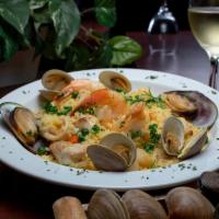 Paella · Jumbo shrimp, fish, mussels, calamari, baby scallops and clams mixed with saffron rice.