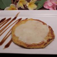 Arepa De Chocolo Con Queso · Sweet corn cake topped with cheese.