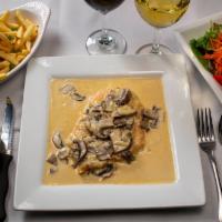 Pollo Con Champiñones · Chicken breast sautéed with mushrooms sauce. Served with rice.