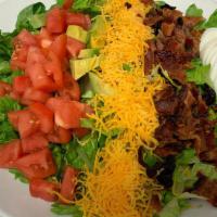 Western Cobb Salad · Layers of crisp bacon, fresh avocado, hard boil egg, tomatoes, and cheddar over romaine lett...