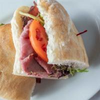 Roast Beef Sandwich · Fresh sliced roast beef, swiss cheese, horseradish sauce, mixed greens, and tomato on grille...