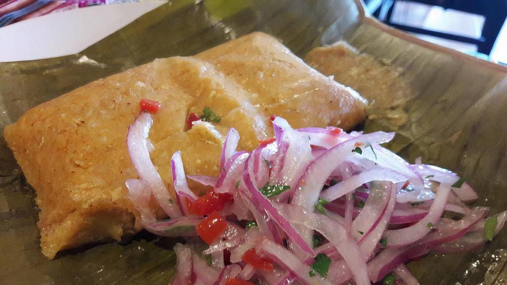 Tamales · Homemade Peruvian tamale, served with a side of salsa criolla.