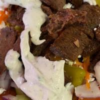 Gyro Greek Salad · Greek salad topped with tender gyro meat.