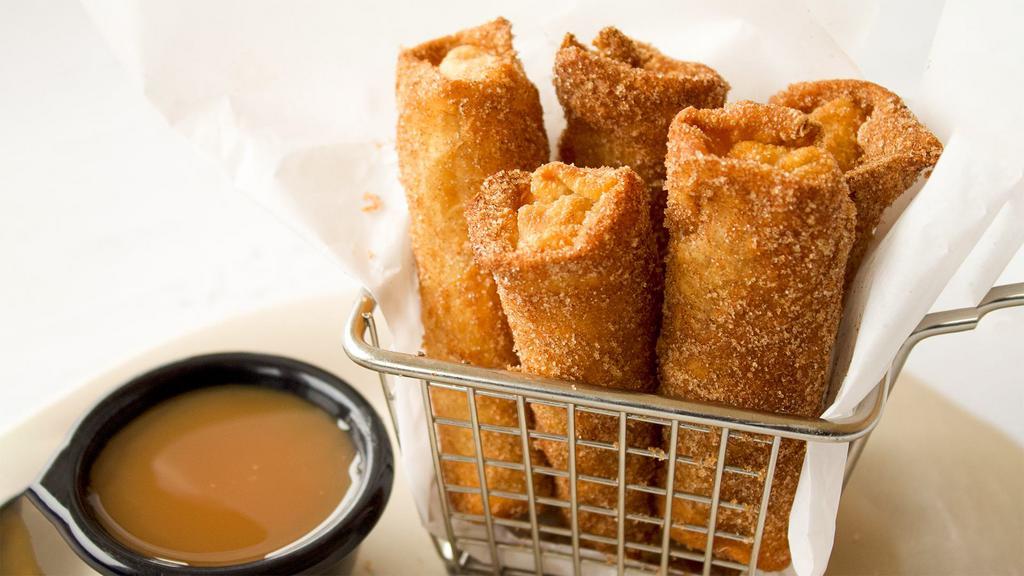 Apple Pie Egg Rolls · Five crispy egg rolls filled with warm apple pie filling and rolled in cinnamon sugar. Served with silky caramel sauce.