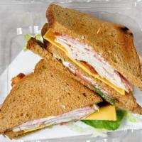 Club Sandwich · Three layers of roasted Turkey, ham, and bacon. Served with cheese, lettuce, and tomatoes on...