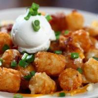Nacho Tots · Tots topped with melted queso, bacon, and scallions. Served with your choice of ranch or sou...