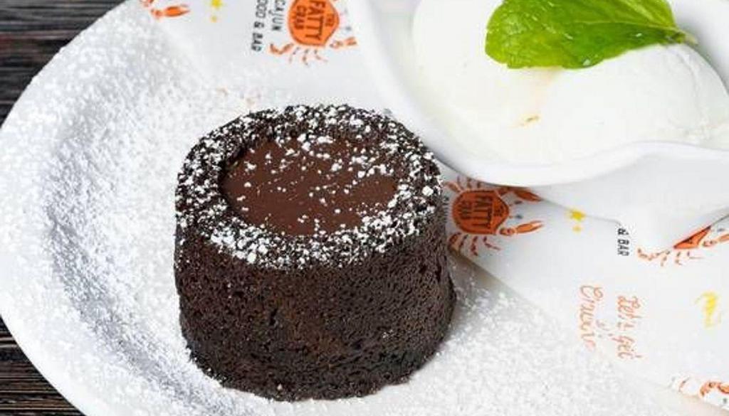 Chocolate Molten Lava Cake · Molten cake, ice cream, oreo crumb, and chocolate syrup.