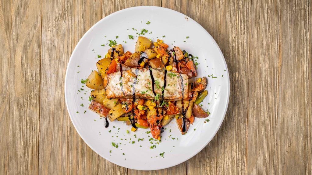 Rosemary Salmon · Served with medley vegetables, potatoes, asparagus, corn, and tomato with balsamic reduction and lemon butter sauce.