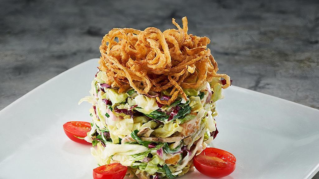 Ruth'S Chop Salad · Our original... julienne iceberg lettuce, baby spinach, radicchio, red onions, mushrooms, green olives, bacon, eggs, hearts of palm, croutons, bleu cheese, lemon basil dressing, crispy onions