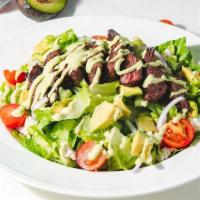 Skirt Steak Salad · Skirt steak, grilled corn, cherry tomatoes, avocado, red onions, and blue cheese, with cilan...