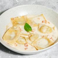 Lobster Ravioli · Lobster Ravioli with a light creamy white wine sauce topped with diced tomatoes