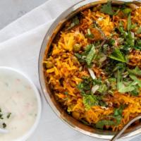 Kashmiri Vegetable Biryani · Basmati rice cooked with seasonal vegetables and Indian herbs served with raita.