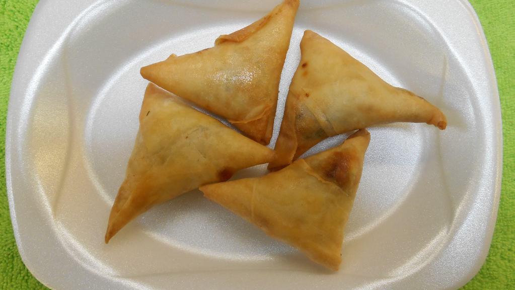 Beef Samosa (4 Pcs) · A fried triangular savory pastry containing beef, herb, and spices. Served with green chutney.